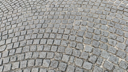 Fototapeta premium classic cobblestone pavement laid out in a distinct, fan-shaped or arched pattern.