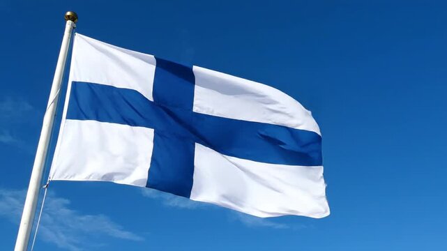 Finnish flag waving against a clear blue sky, national symbol of Finland blowing in the wind.