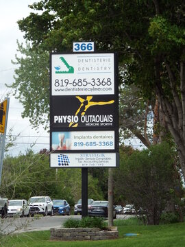 Gatineau,Quebec, Canada &ndash; May 24, 2026: The sign at 366 Chem. d'Aylmer displays advertisements for "Dentistrie Dentistry, Physio Outaouais, and various local Imp&ocirc;ts-Services Comptables Tax-Accounting 