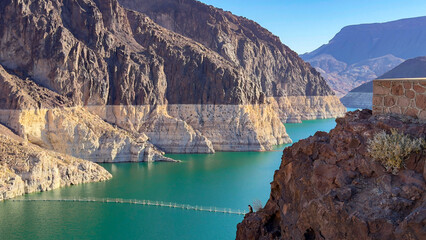 Elevated view of Lake Mead reservoir with turquoise water and prominent bathtub ring on the rugged canyon walls near Hoover Dam © Vit Onopriienko