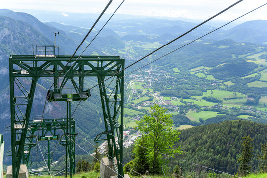 Rax Austria captured on June 6 2022 features a vibrant green cable car set against stunning alpine mountains and the lush green valley below bathed in natural light
