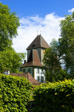 Schloss Jegenstorf castle tower rising above green trees in summer