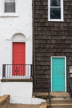 Contrasting red and teal doors on urban houses