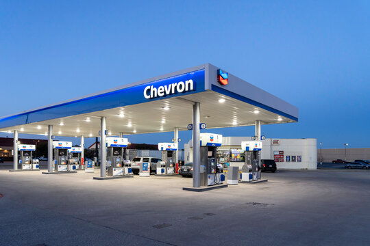 Dallas, Texas, USA - March 19, 2022: Night view of a Chevron gas station in Dallas, Texas, USA. Chevron Corporation is an American multinational energy corporation.