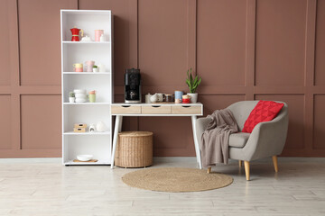 Cozy home interior with a coffee station, bookshelf, and armchair against a brown paneled wall © Pixel-Shot