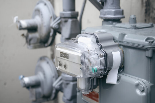 Natural gas meter outside, close up. Outdoor meter measuring and displaying usage number in cubic feet. For residential multi-dwelling building or home. Vancouver, BC, Canada. Selective focus.