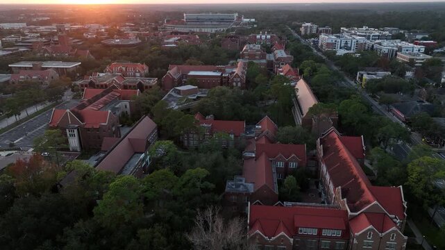 The setting sun illuminates the buildings of historic downtown Gainesville, Florida, USA.