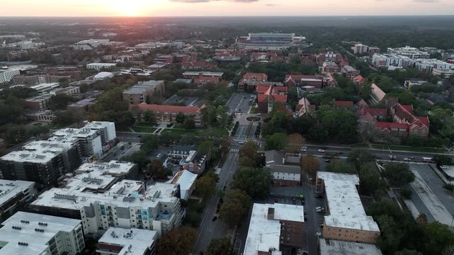 The setting sun illuminates the buildings of historic downtown Gainesville, Florida, USA.