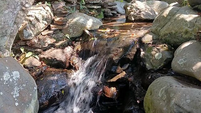 water flowing in the rocky  river