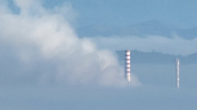 Operating Petrochemical Refinery Releasing Smoke: Pollution and Climate Challenges in Aerial View Amidst the Clouds