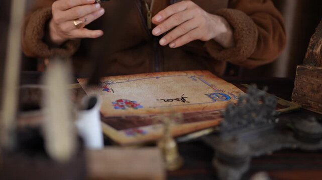 Scribe writing calligraphy on antique paper