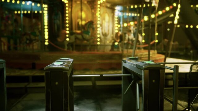 Locked turnstiles blocking silent carousel platform, rusted metal gates and ticket readers in shallow focus, moody amber illumination and deserted midway