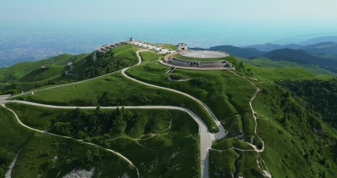 Sacrario Militare del Monte Grappa And Winding Paths On The Green Slopes Of Monte Grappa In Veneto, Italy. aerial orbiting shot