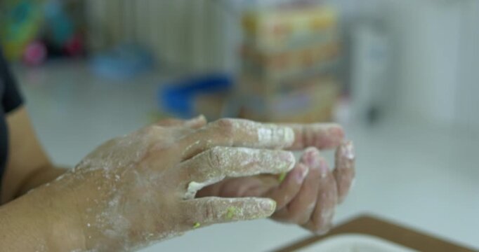 Hand-rolling colorful dough for traditional thai dessert. highlighting the meticulous preparation of authentic asian sweets to create the authentic thai bua loi dessert.