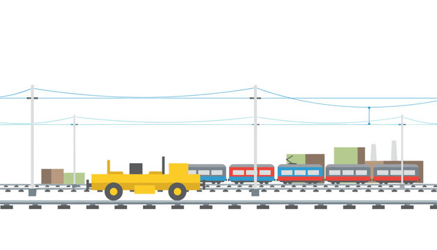 Yellow maintenance rail vehicle sits on tracks near a passenger train against a cloudy industrial skyline with overhead power lines and cables.
