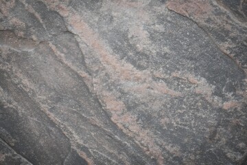 Fototapeta premium Grey granite surface with diagonal pink veins background texture