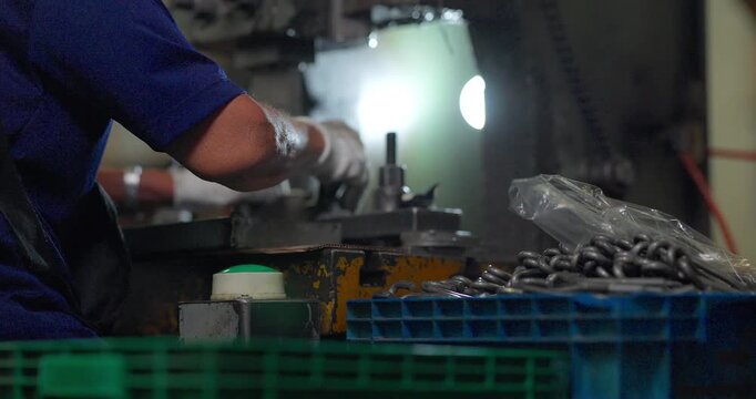 Metal stamping press machine punching and forming small metal parts one by one in factory