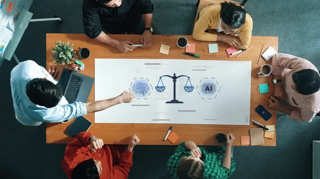 A diverse team engages in a focused discussion about AI ethics, using a balance scale graphic at a modern office workspace. Creativity and collaboration thrive in this setting. Raster