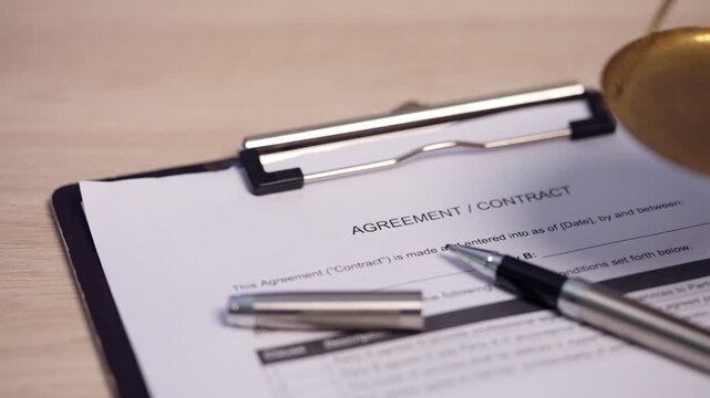 Business Agreement Contract with Pen and Scales of Justice on Office Desk