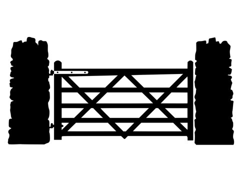Black silhouette of a traditional wooden farm gate between stone pillars