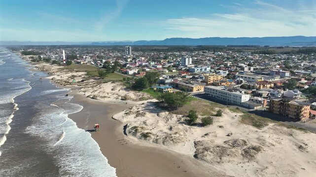 Arroio do Sal coastal cityscape with sandy beach, ocean waves, and urban buildings