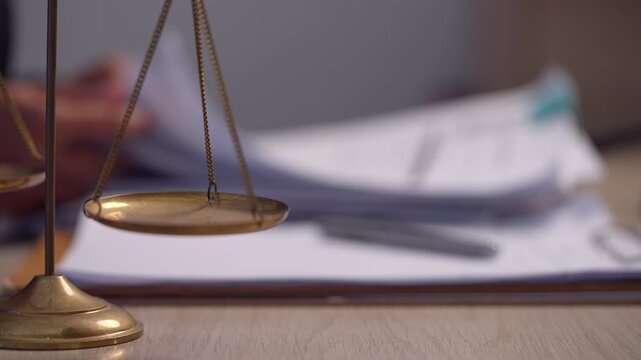 Scales of Justice on Legal Documents in Law Office During Case Review