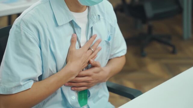 Employee suffering from severe acid reflux or sudden chest pain in office.