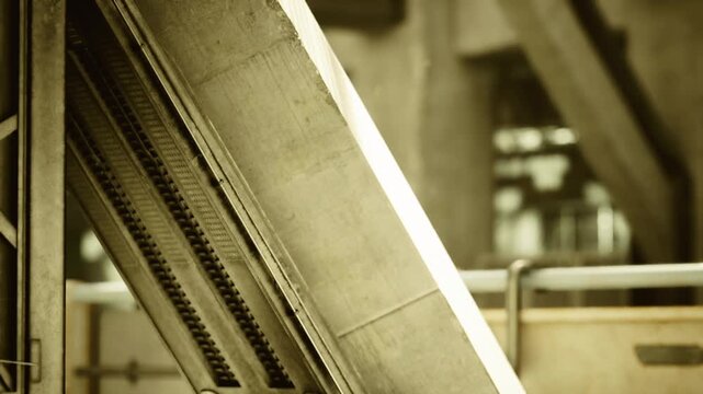 Angled steel beam detail industrial station interior, closeup of riveted support showing texture, patina and mechanical joints under warm cinematic light,