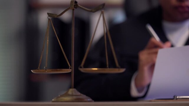 Lawyer Reviewing Legal Documents Before Court Filing with Scales of Justice