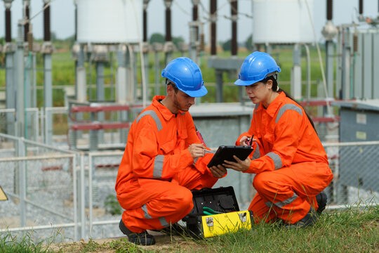 Electrical engineers are checking the operation and power distribution systems within the substation receiving power from the wind farm.	