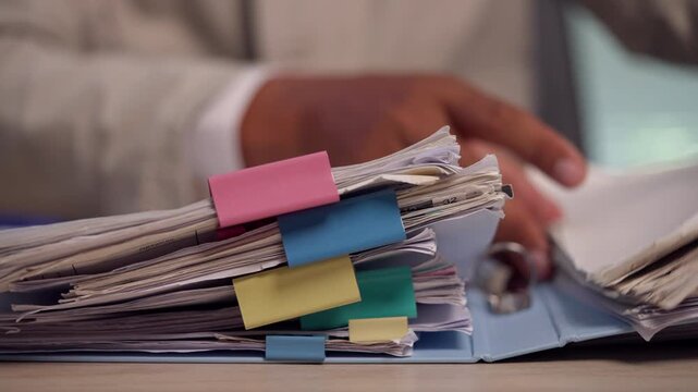 Lawyer Reviewing Legal Case Documents and Organizing Client Files