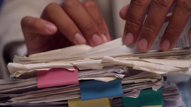 Attorney Organizing Legal Case Files and Reviewing Documents at Office Desk
