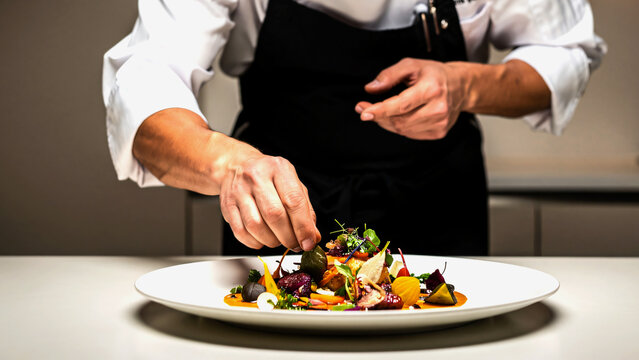 High-end chef plating gourmet fine dining dish in studio kitchen, artistic composition, dramatic soft lighting, detailed textures of food and plating, minimalistic background, luxury culinary concept.