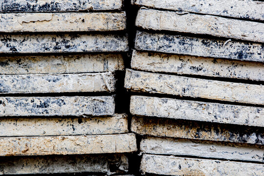 The texture of a precast cement panel is used as a background.