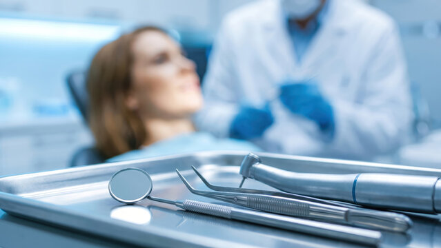 Close-up of sterile dental tools on a tray, ready for a patient examination.