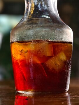 Close-up of a glass decanter/carafe filled with cold brew iced coffee and condensation droplets.