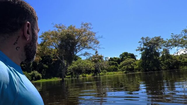 Traveler searching for pink river dolphins in Pampas de Yacuma, Bolivia