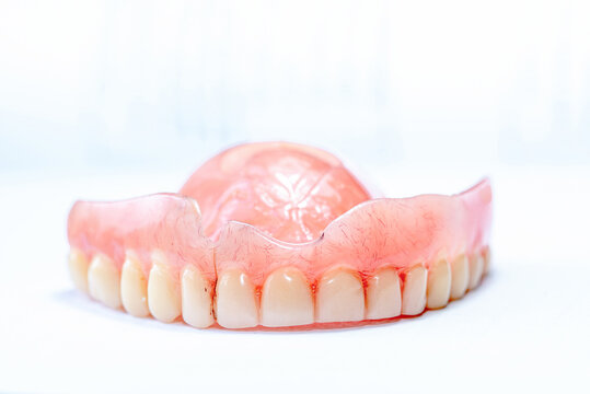 
Old Complete Denture with Cracked Acrylic Base Isolated on White Background