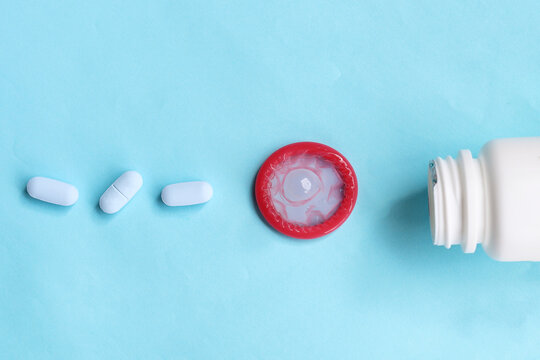 Close-up of HIV prevention concept featuring PrEP medication and a condom