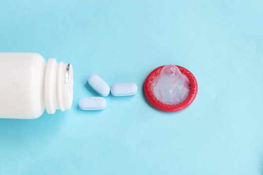 Close-up of HIV prevention concept featuring PrEP medication and a condom
