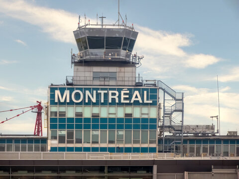 Montreal, Quebec, Canada. July 14, 2026. Close-up of the Montreal-Trudeau Airport control tower with the city name on its blue facade.