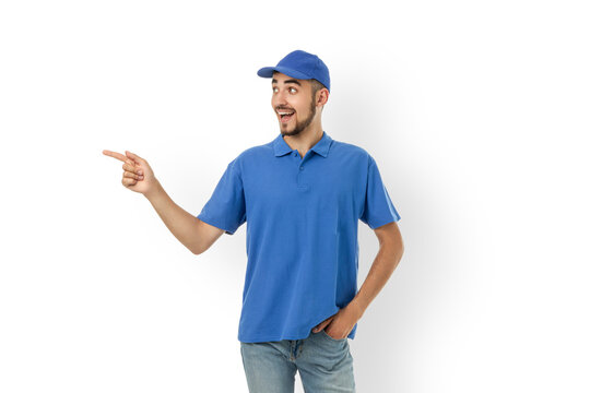 Delivery man wearing a blue uniform and cap pointing, isolated, PNG