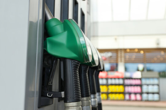 Green fuel nozzle is ready at a modern refueling station