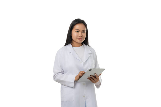 Young doctor with long hair using tablet, isolated on white, PNG