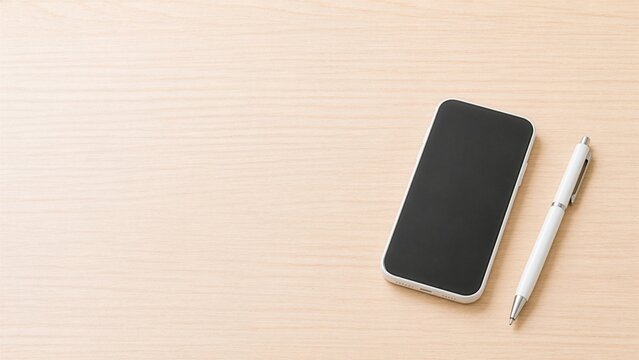 Minimal smartphone and white ballpoint pen on light wooden desk with copy space