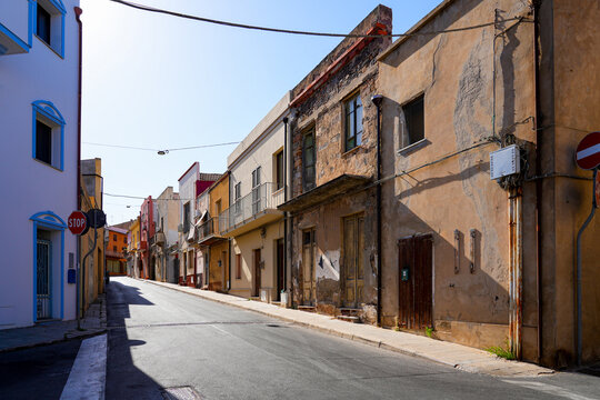 Traditional narrow street with colorful houses in the town of Sant'Antioco, Sardinia, Italy