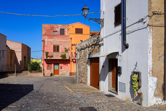 Traditional narrow street with colorful houses in the town of Sant'Antioco, Sardinia, Italy