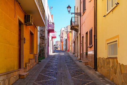 Traditional narrow street with colorful houses in the town of Sant'Antioco, Sardinia, Italy