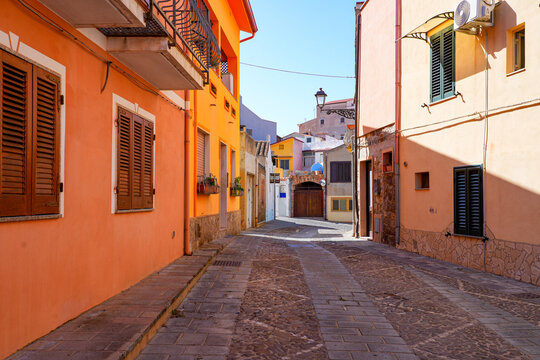 Traditional narrow street with colorful houses in the town of Sant'Antioco, Sardinia, Italy