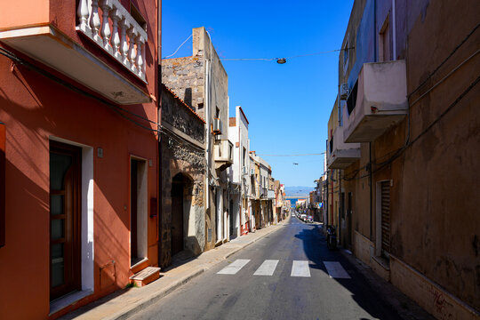Traditional narrow street with colorful houses in the town of Sant'Antioco, Sardinia, Italy